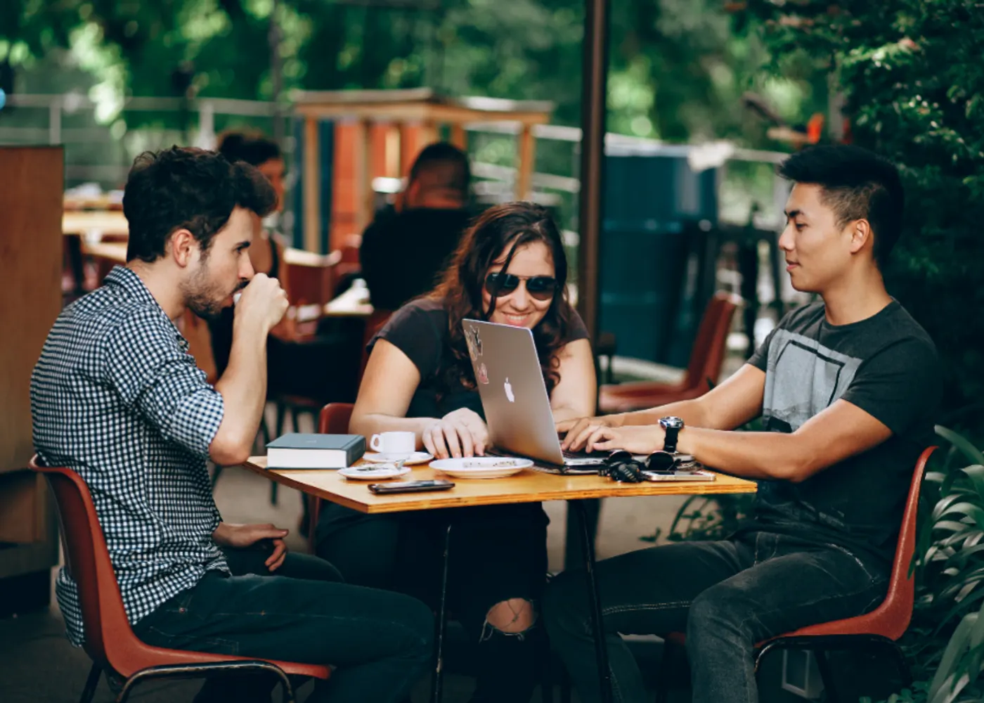 A designer and a developer reviewing a website layout on a laptop